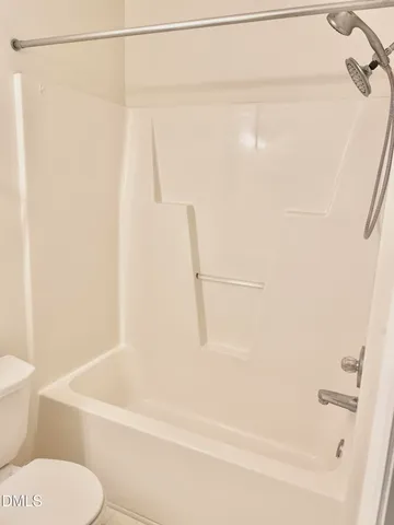 a bathroom with a shower and a toilet