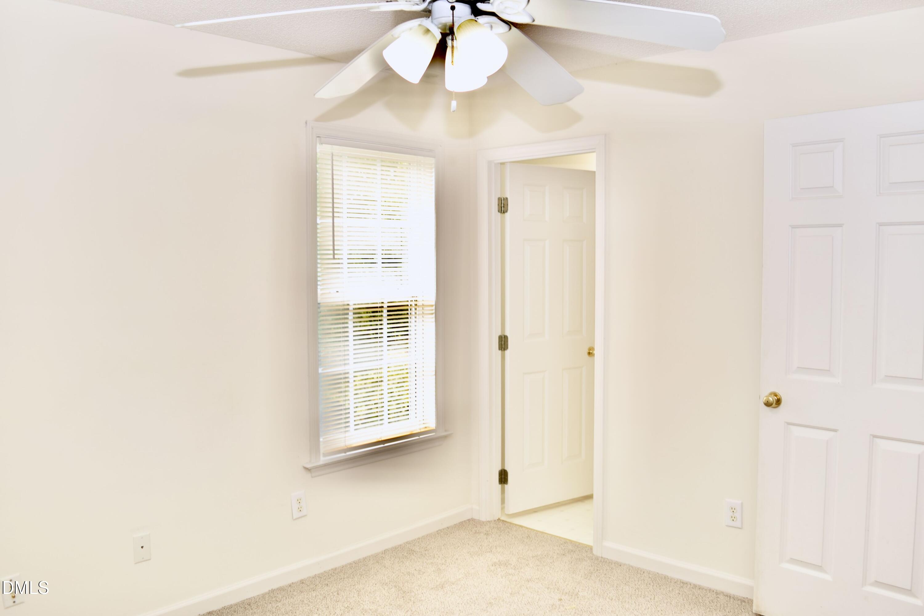 5100 Mass Rock Drive Raleigh, NC 27610 - Photo 26 of 30 an empty room with a windows and chandelier fan