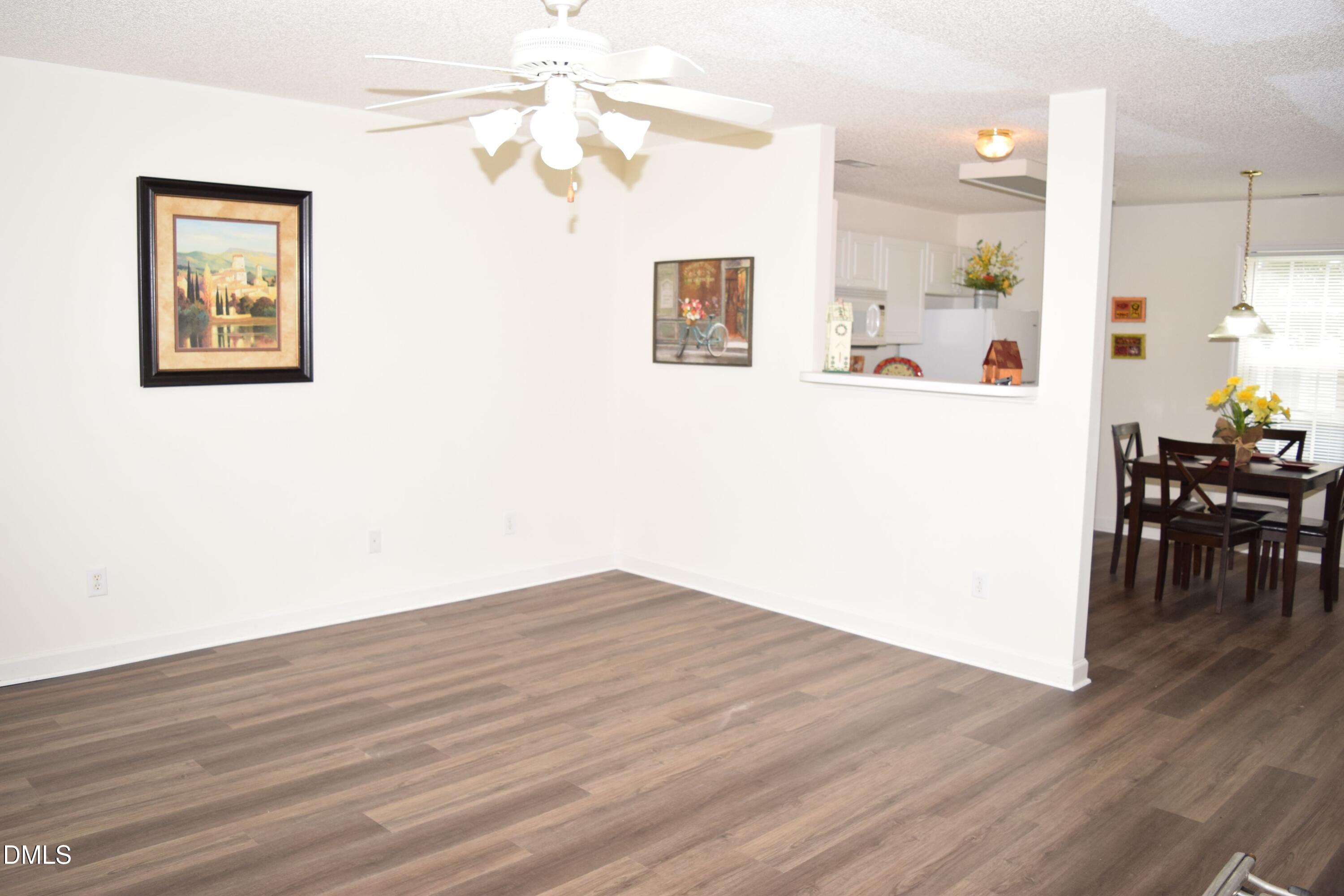5100 Mass Rock Drive Raleigh, NC 27610 - Photo 5 of 30 a view of kitchen with livingroom and wooden floor