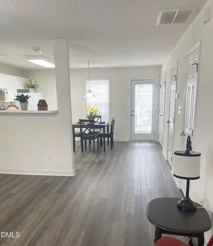a view of a livingroom with furniture and hardwood floor