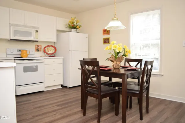 a view of a dining room with furniture window and wooden floor