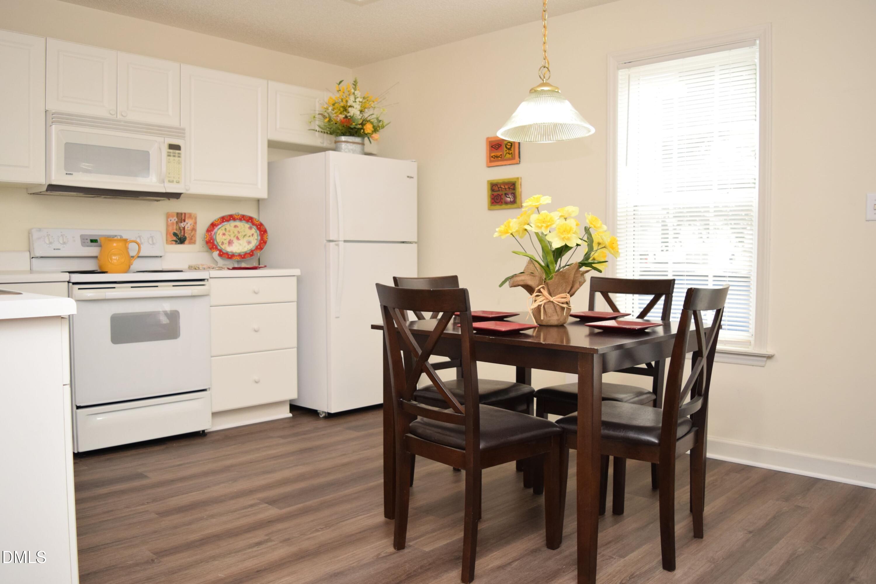 5100 Mass Rock Drive Raleigh, NC 27610 - Photo 8 of 30 a view of a dining room with furniture window and wooden floor