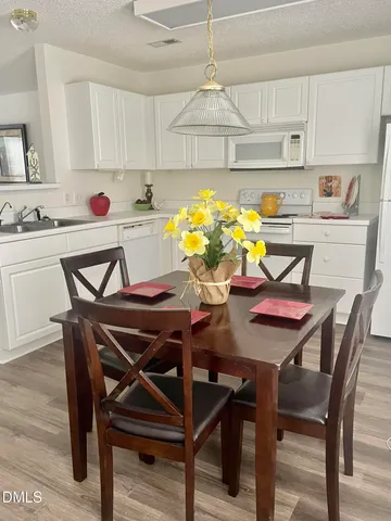 a view of a dining room with furniture and chandelier