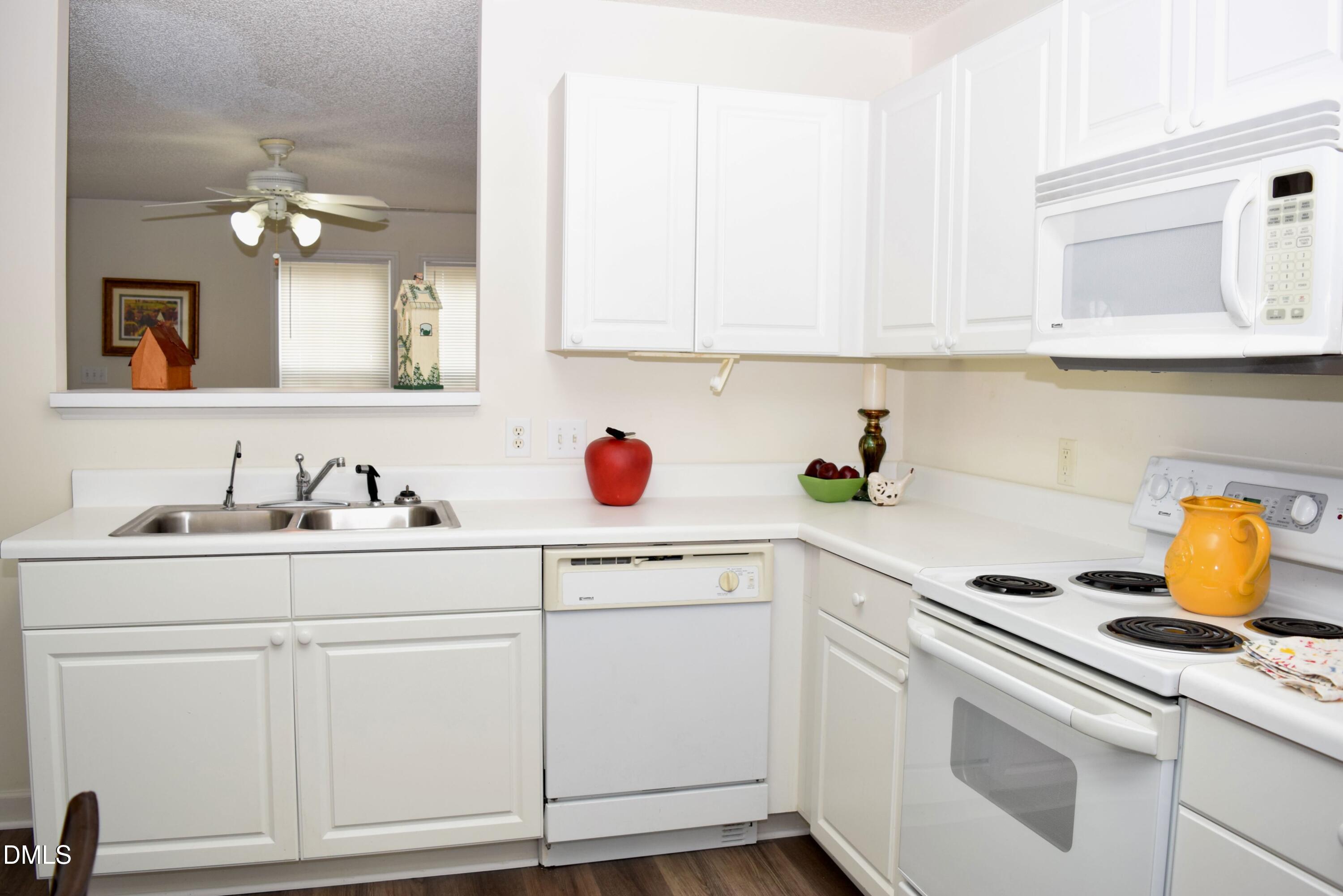 5100 Mass Rock Drive Raleigh, NC 27610 - Photo 10 of 30 a kitchen with white cabinets and white appliances