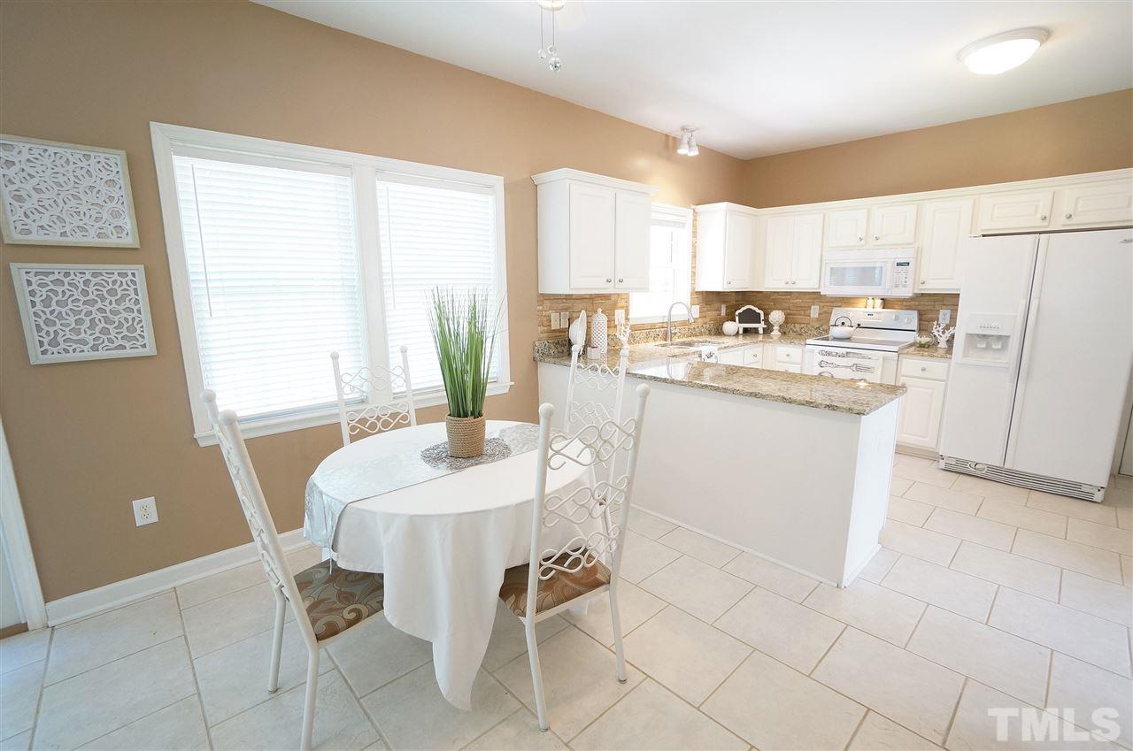 8400 Neuse Rapids Road Raleigh, NC 27616 - Photo 4 of 20 Bright & open kitchen has a spacious layout, granite counter tops, tile floor & a lot of charm.