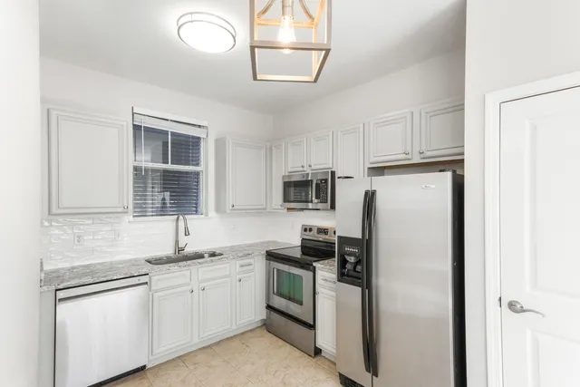 a kitchen with granite countertop white cabinets and a granite counter tops