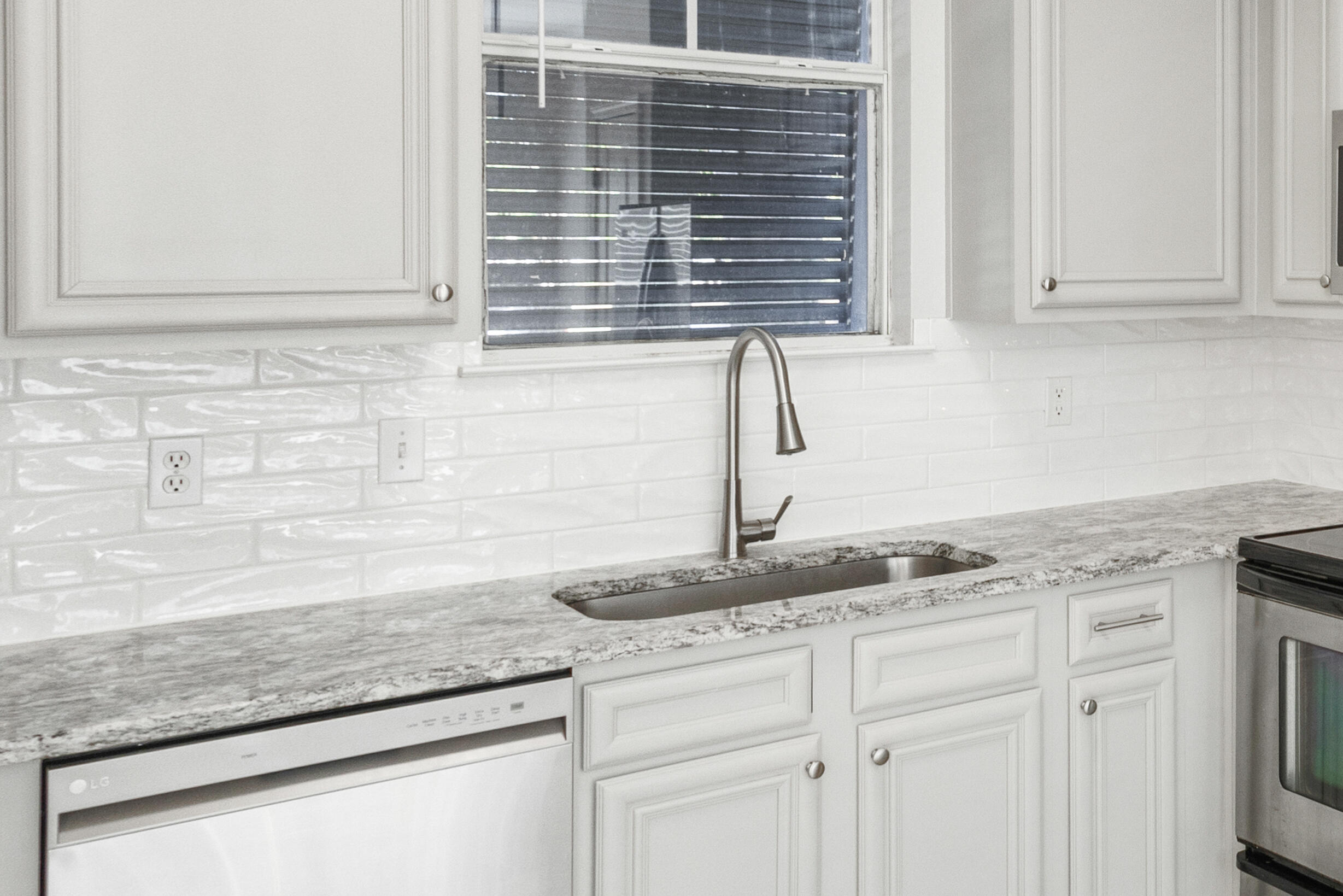24 Talon Court, Unit C Santa Rosa Beach, FL 32459 - Photo 14 of 29 a kitchen with granite countertop white cabinets and a granite counter tops