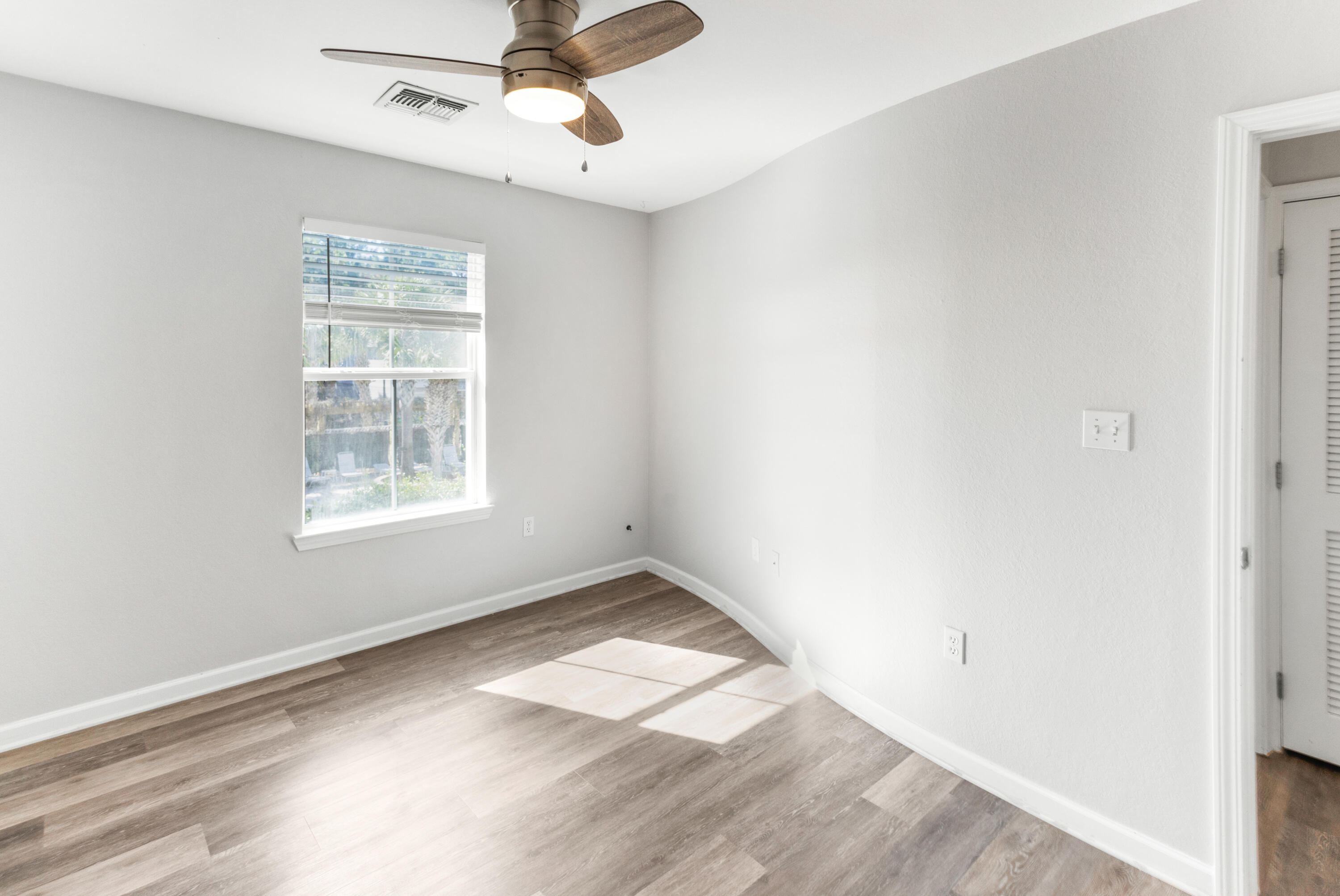 24 Talon Court, Unit C Santa Rosa Beach, FL 32459 - Photo 19 of 29 an empty room with a window and ceiling fan