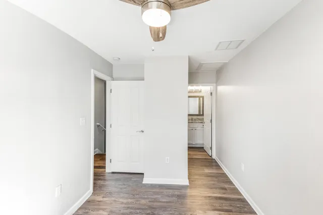 a bathroom with a granite countertop sink mirror vanity and toilet