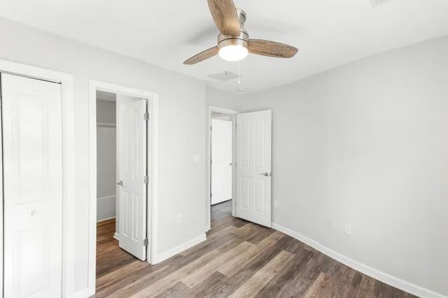a view of room with window and wooden floor