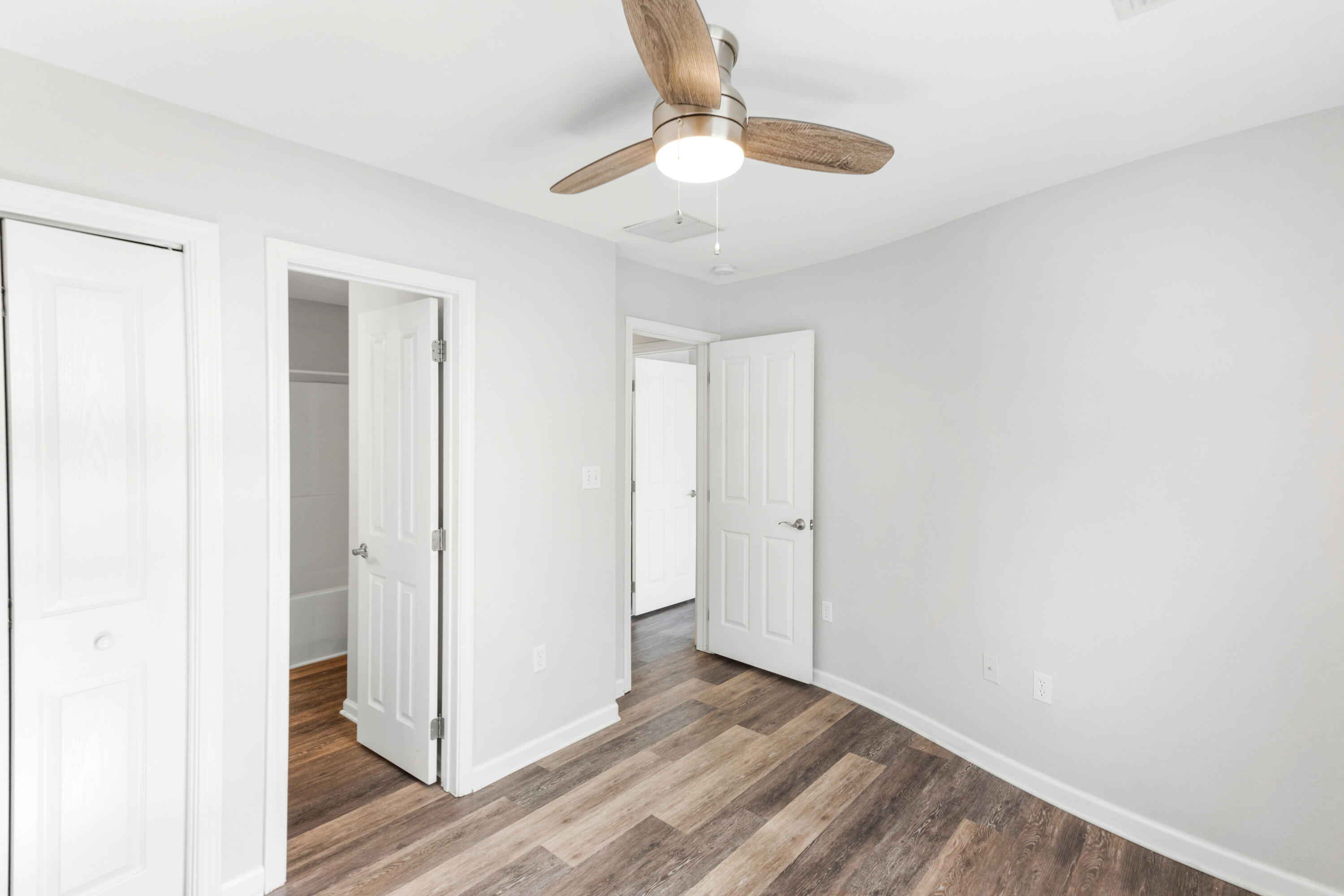 24 Talon Court, Unit C Santa Rosa Beach, FL 32459 - Photo 23 of 29 a view of an empty room with wooden floor