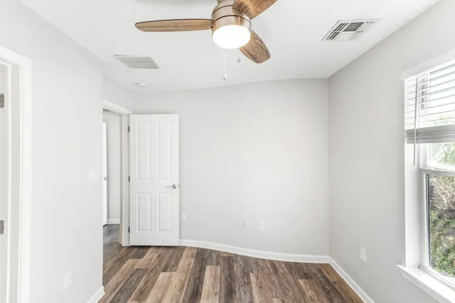 a white toilet sitting next to a bath tub