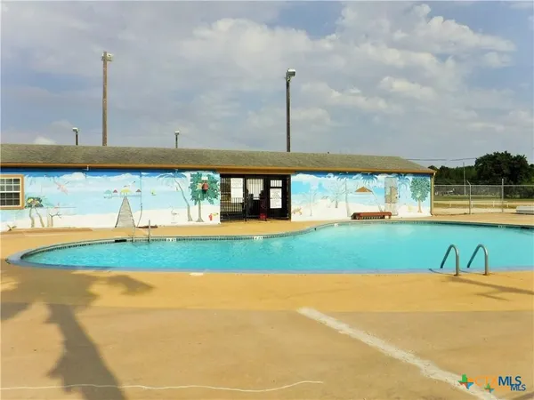 a view of a swimming pool with a yard