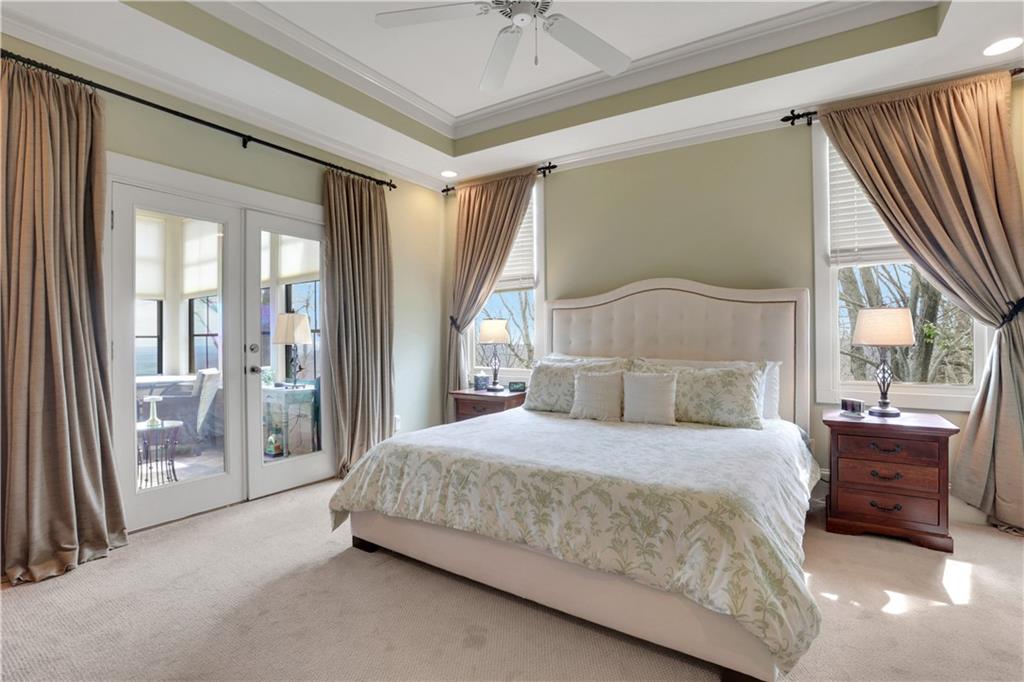 79 Strawberry Way Jasper, GA 30143 - Photo 26 of 67 a bedroom with a large bed and a chandelier