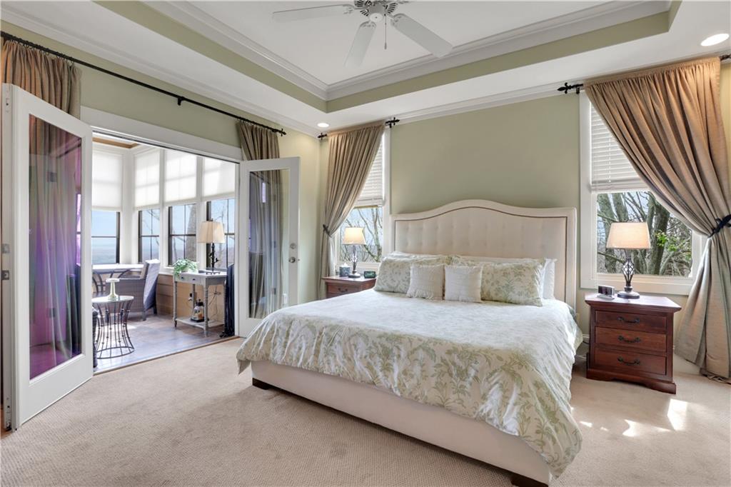 79 Strawberry Way Jasper, GA 30143 - Photo 28 of 67 a bedroom with a large bed and a chandelier