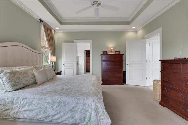 a bedroom with a large bed and a chandelier
