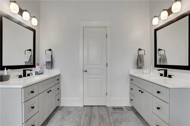 a living room with furniture a chandelier and a bookshelf