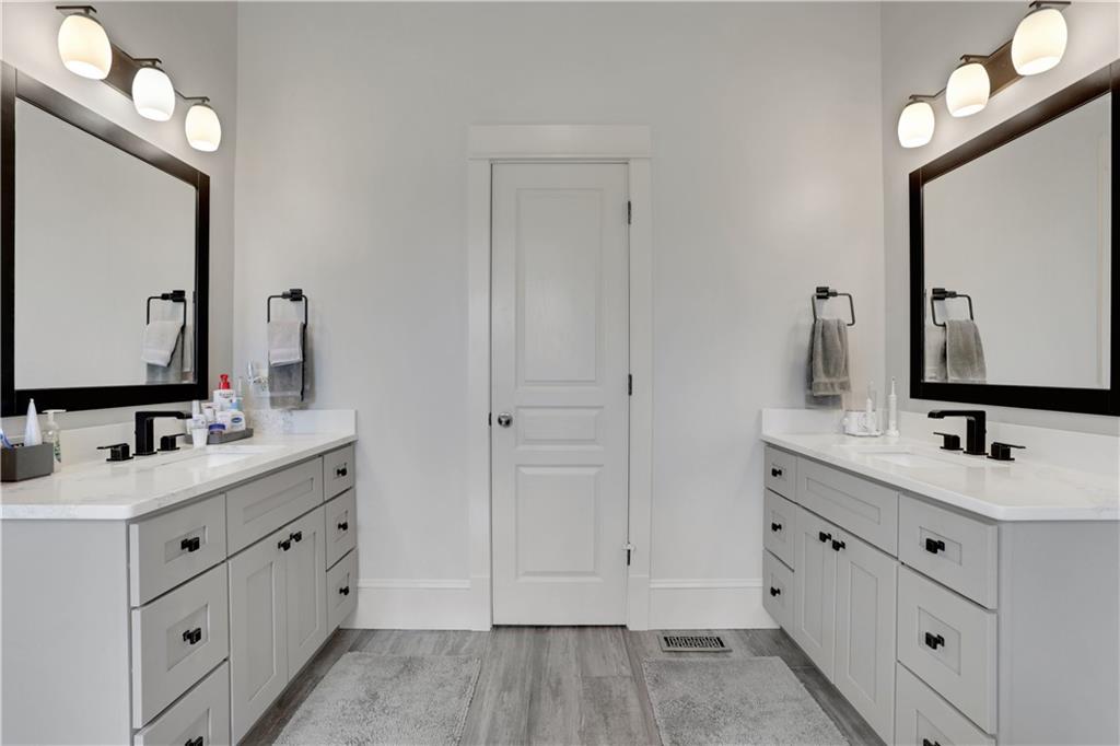 79 Strawberry Way Jasper, GA 30143 - Photo 31 of 67 a bathroom with a double vanity sink mirror and