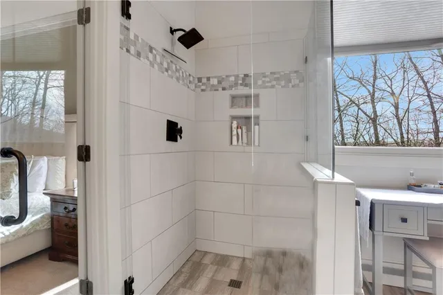 a bathroom with a toilet sink vanity tub and shower