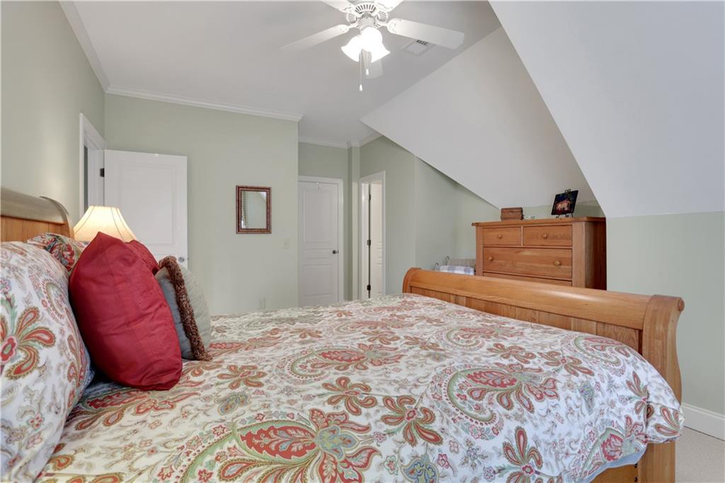 79 Strawberry Way Jasper, GA 30143 - Photo 38 of 67 a bedroom with a bed and a chandelier