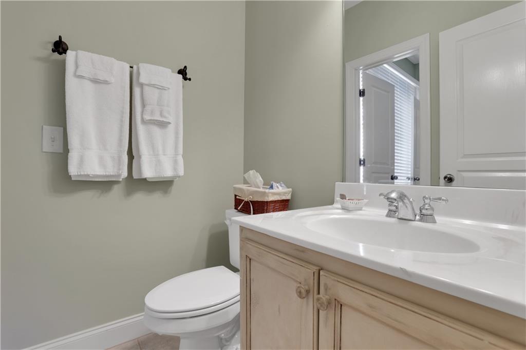 79 Strawberry Way Jasper, GA 30143 - Photo 39 of 67 a bathroom with a sink vanity mirror and toilet