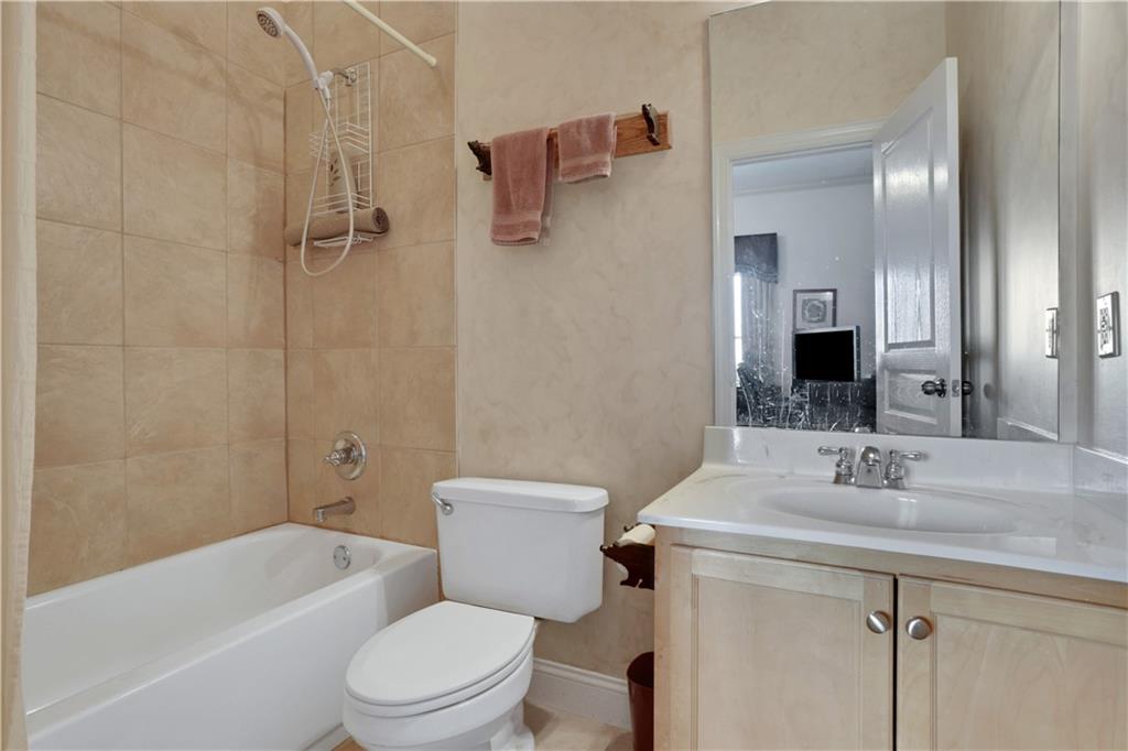 79 Strawberry Way Jasper, GA 30143 - Photo 49 of 67 a bathroom with a toilet sink vanity tub and shower