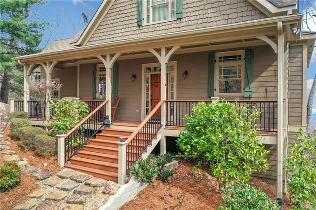 a kitchen with stainless steel appliances granite countertop a stove top oven a sink a dining table and chairs with wooden floor