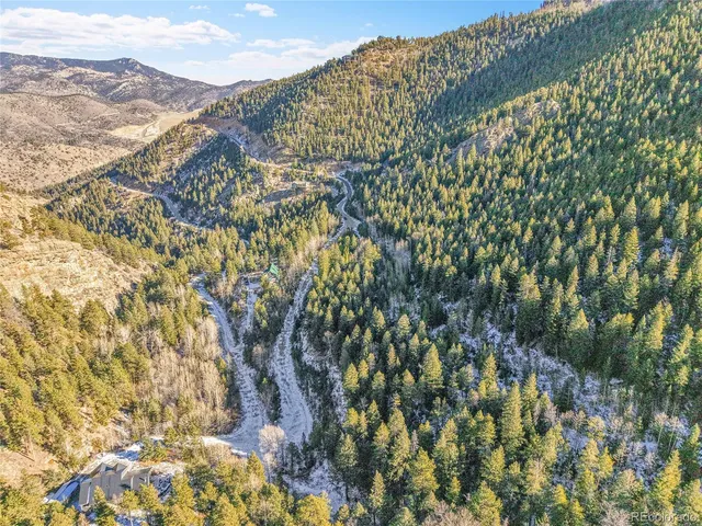 an aerial view of mountain with an ocean