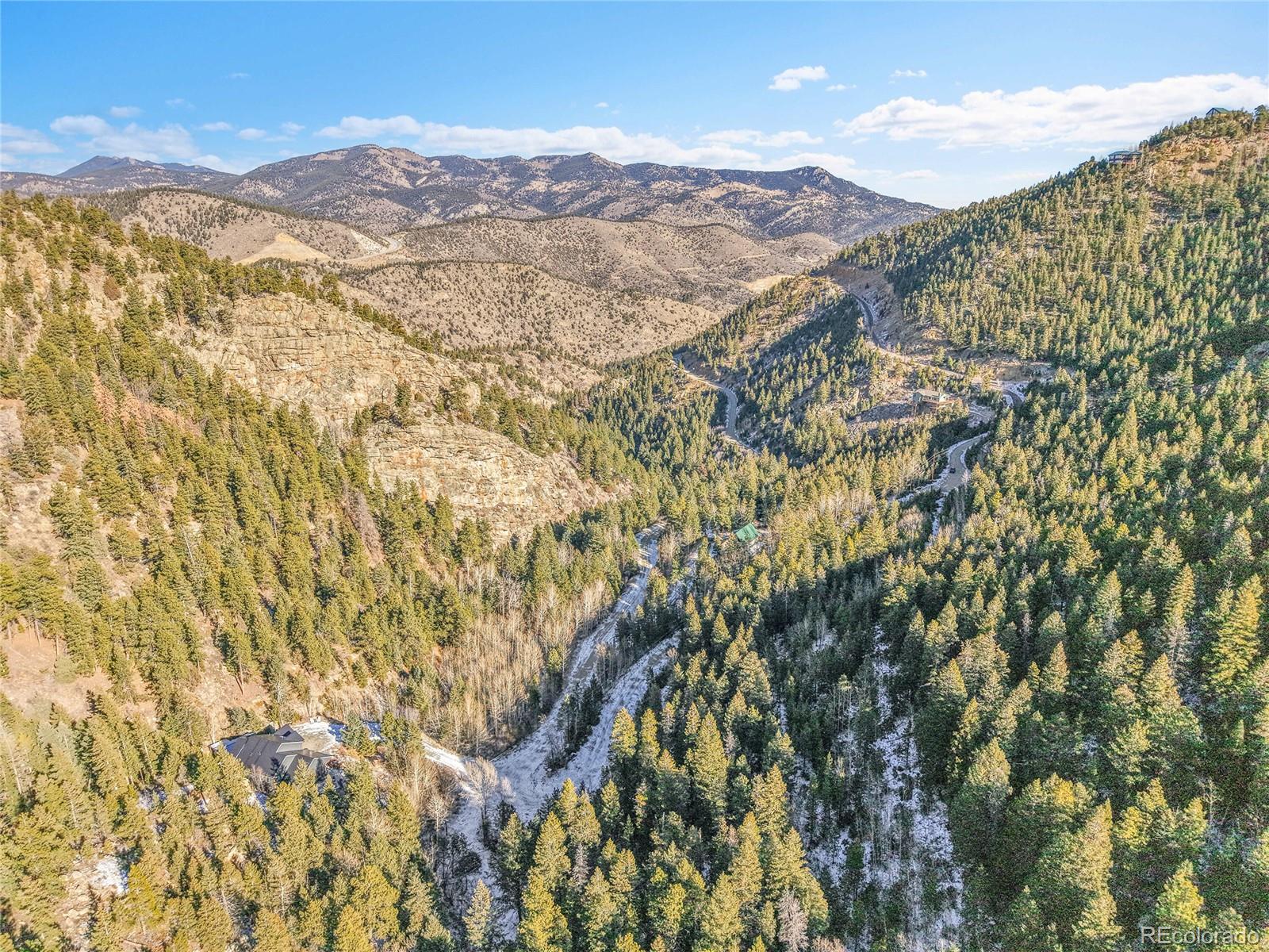 Clear Creek Rd Road Evergreen, CO 80439 - Photo 23 of 33 a view of a field with mountains in the background