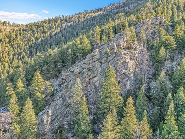 a view of a large mountain with mountains in the background