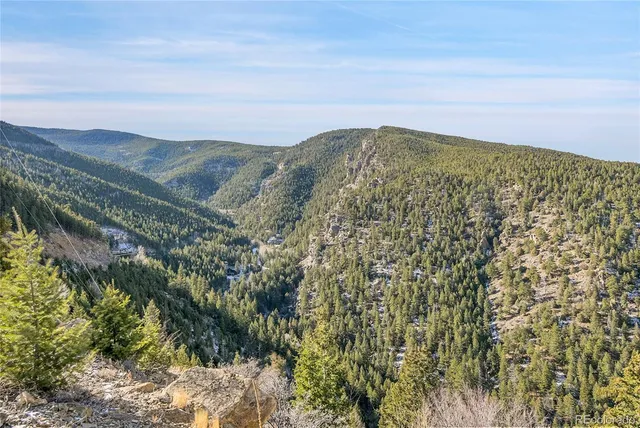 a view of a large building with mountains in the background