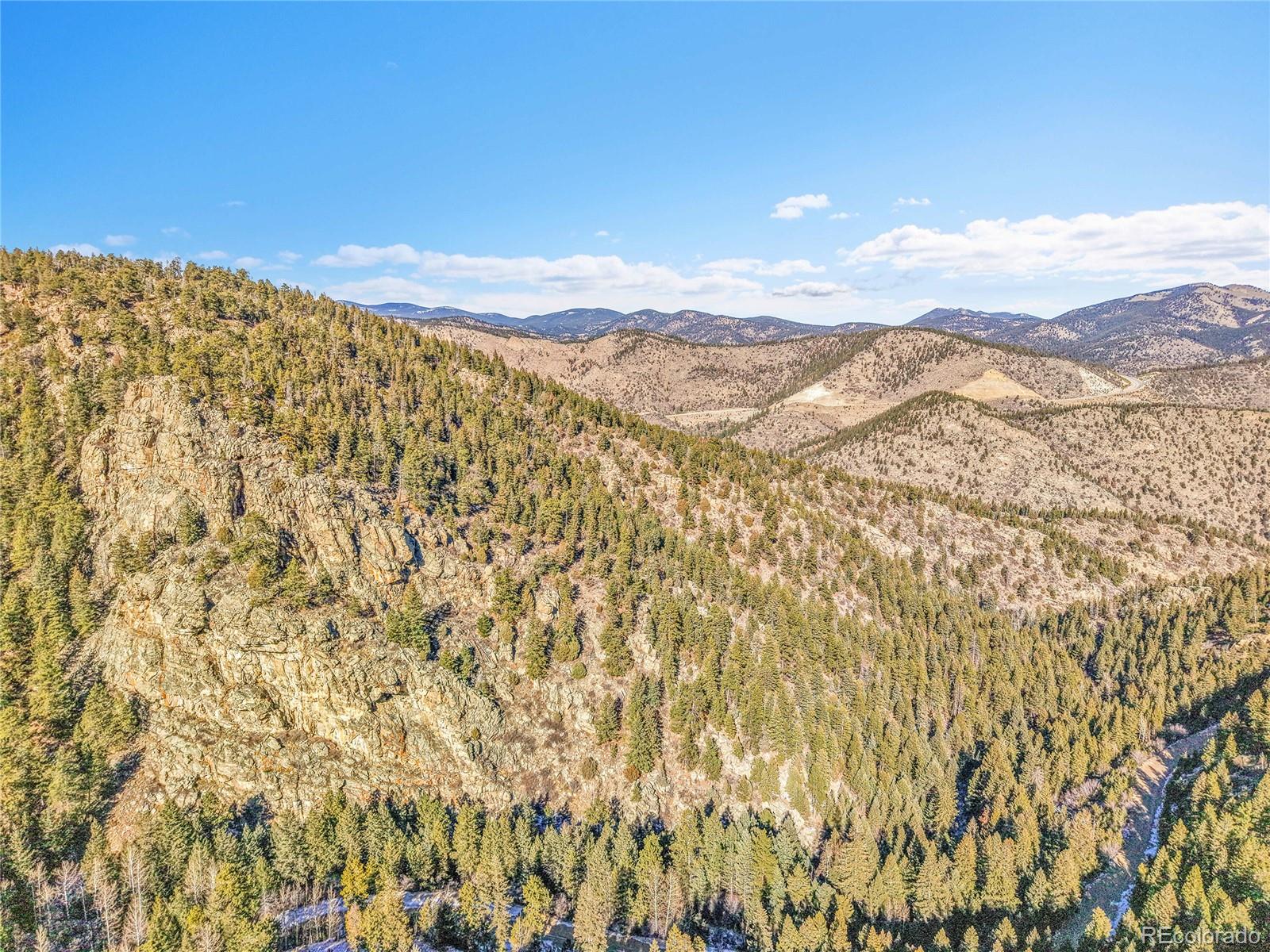 Clear Creek Rd Road Evergreen, CO 80439 - Photo 27 of 33 a view of a large mountain with mountains in the background