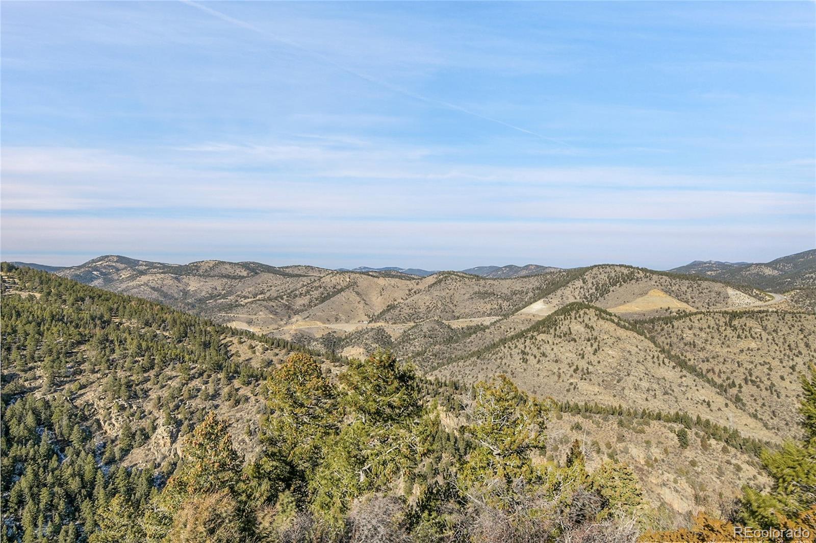 Clear Creek Rd Road Evergreen, CO 80439 - Photo 28 of 33 a view of a large building with mountains in the background
