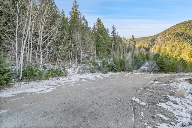 a view of a dirt road with a building in the background