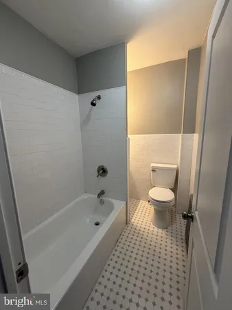 a bathroom with a bathtub and toilet