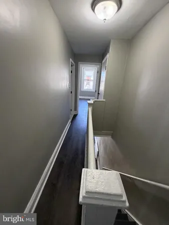 a view of a hallway with furniture and entryway