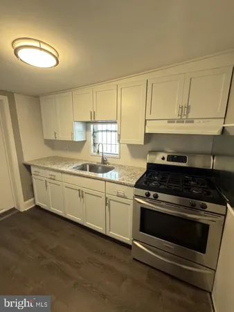 a kitchen with appliances cabinets and a sink