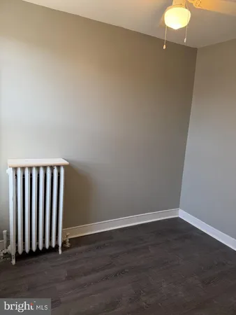 a view of a room with wooden floor and a window