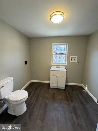 a room with a toilet and a window