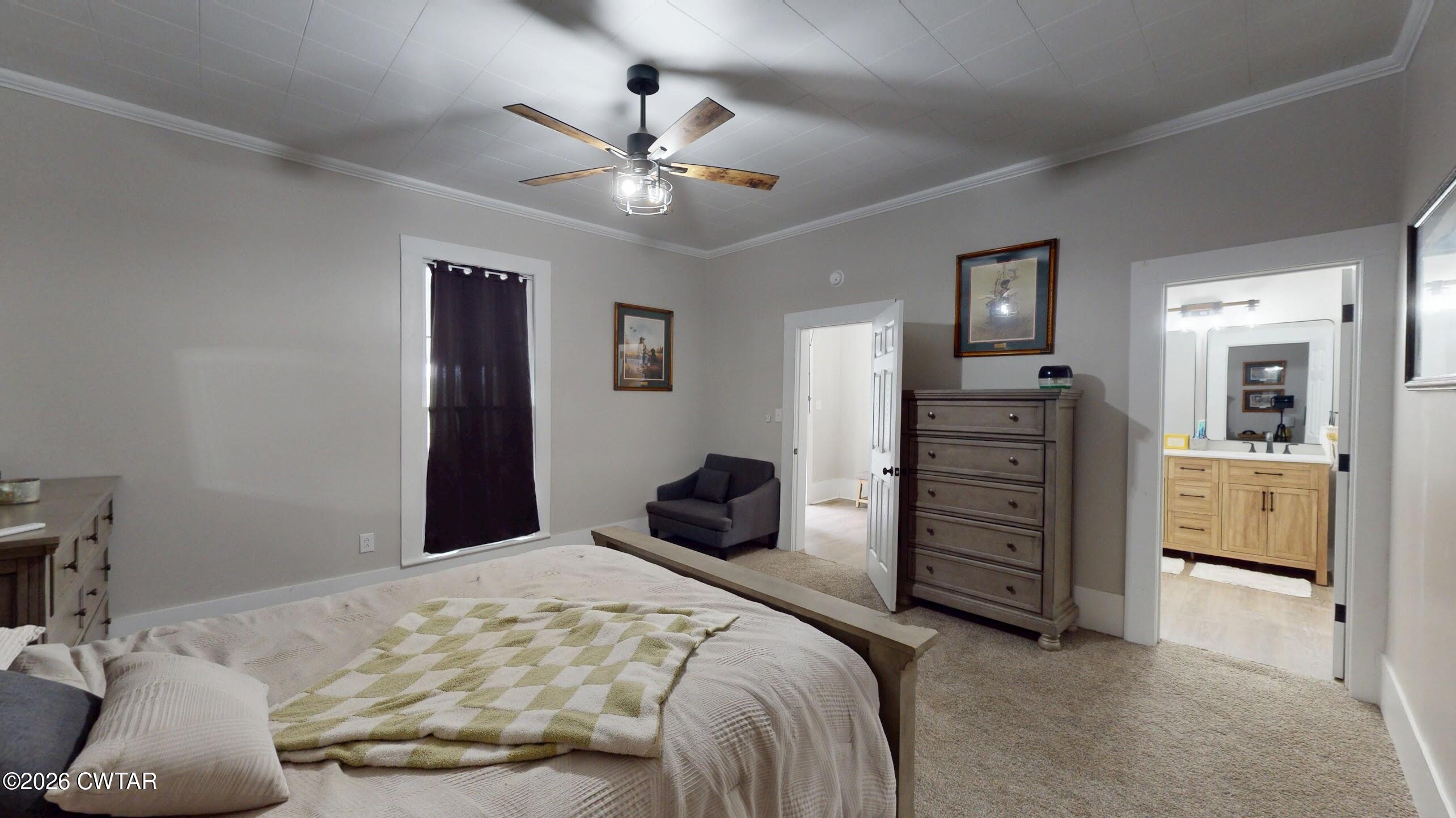 2800 Locust Grove Road Newbern, TN 38059 - Photo 29 of 46 a bedroom with a bed and a chandelier