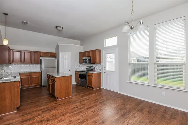 a view of kitchen with sink and microwave