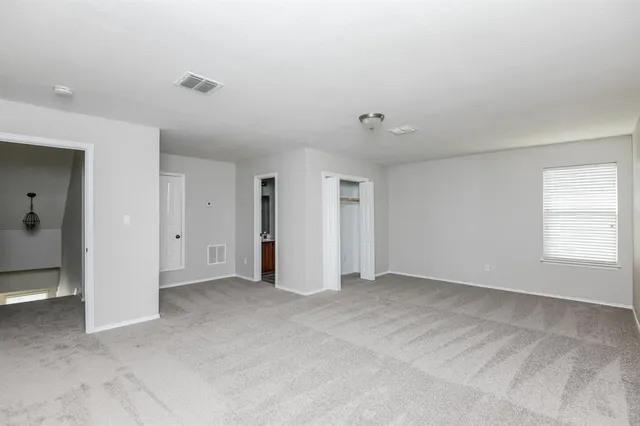 a view of an empty room with a window