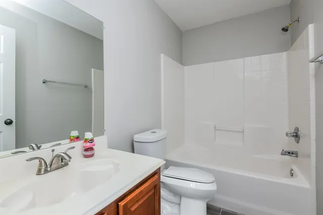 a bathroom with a sink a toilet and a bathtub