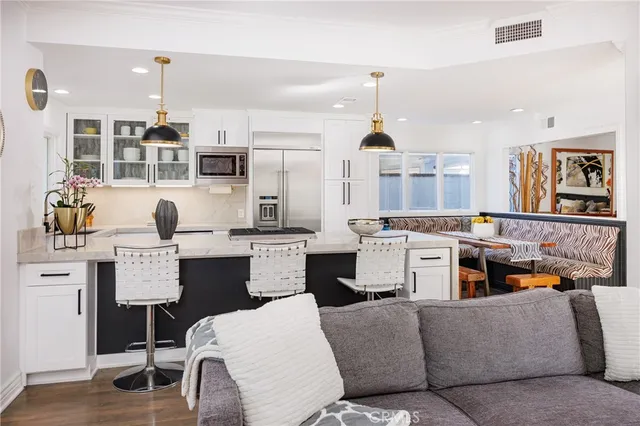 a living room with furniture and kitchen view