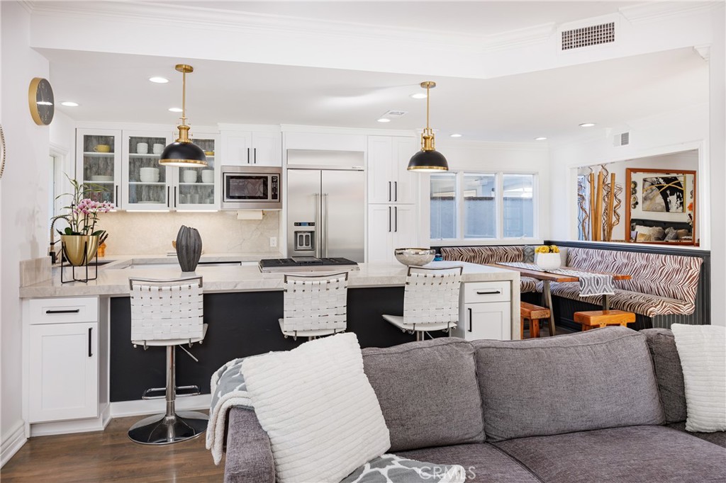 a living room with furniture and kitchen view
