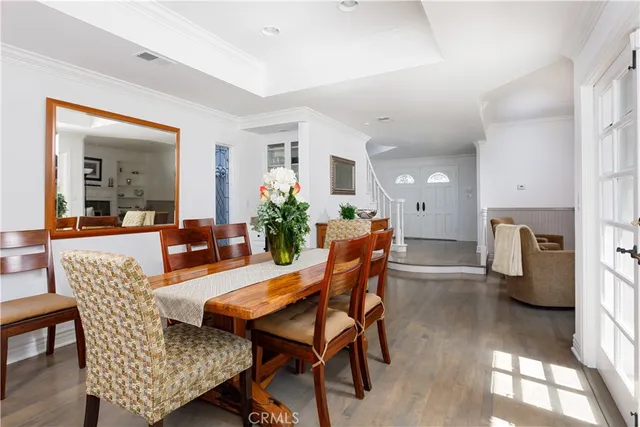 a view of a dining room with furniture and a chandelier