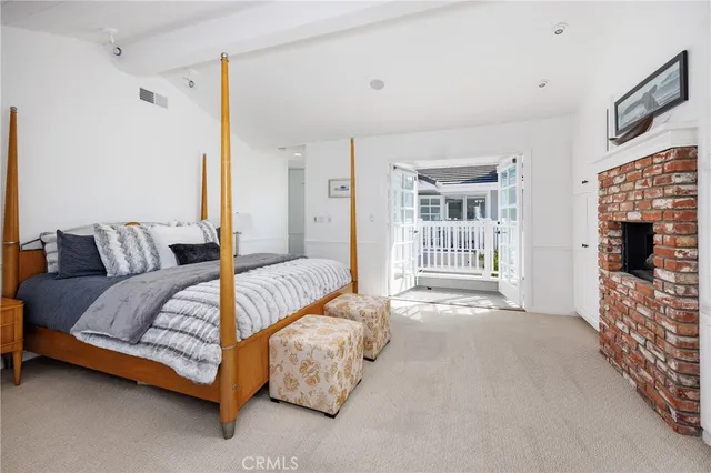 a bedroom with a bed and a fireplace