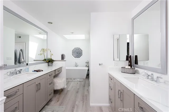 a spacious bathroom with a double vanity sink mirror and