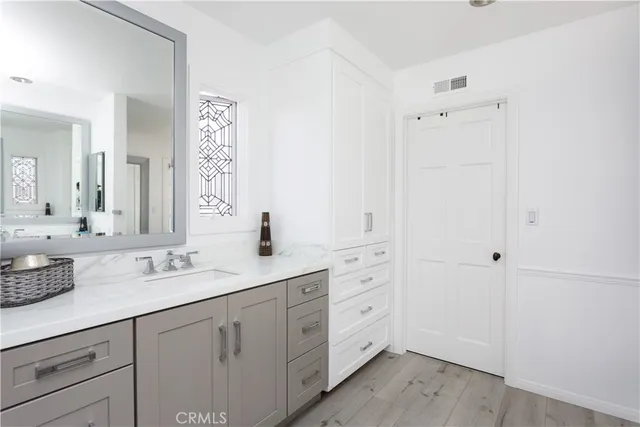 a spacious bathroom with double sink and a mirror