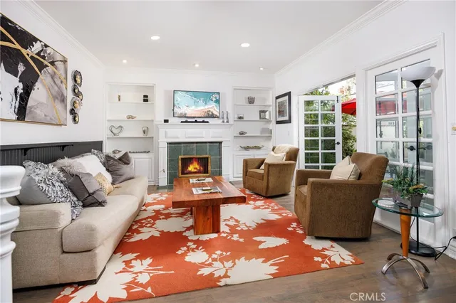 a living room with furniture potted plant and a fireplace
